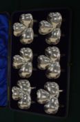A cased set of six silver shamrock shaped dishes.