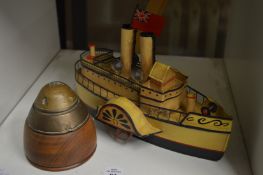 A shell head paperweight and a model paddle boat.