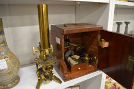 A mahogany cased brass microscope with accessories by W Gray, London.