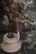 A good small bronze figure of a man smoking a long pipe mounted on a marble socle.