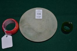 A jadeite dish, an archers ring and another ring.