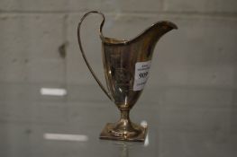 A silver helmet shaped cream jug.