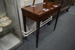 A mahogany rectangular fold-over card table.