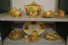 A porcelain part dinner service with fruit and gilt decoration.