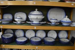 A comprehensive Chamberlains Worcester Armorial dinner service, blue and gilt decorated, the crest