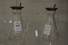 A pair of silver mounted whiskey tots.