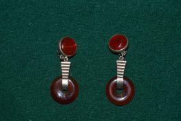 A pair of silver and carnelian ear clips.