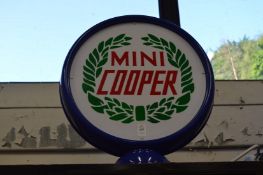 An illuminated double sided sign Mini Cooper.