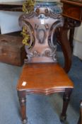 A Victorian mahogany hall chair.