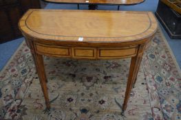 A good George III satinwood and rosewood cross-banded D shaped fold-over card table.