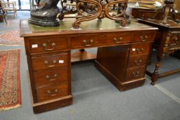 A mahogany pedestal desk.