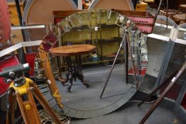 A large modern circular wall mirror.