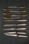 A group of silver handled knives.