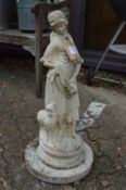 A reconstituted stone garden ornament modelled as a young lady on a circular base.