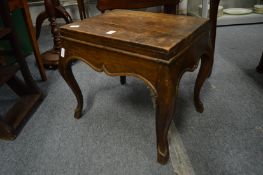 A wooden stool or stand with cabriole legs.