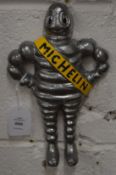 Cast metal wall mounted model of the Michelin man.