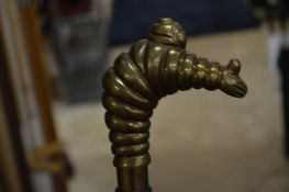 A walking stick, the handle modelled as a Michelin man.