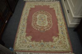 A Chinese pink ground rug, 180cm x 125cm.