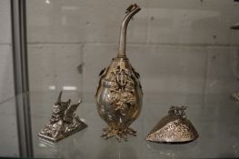 A Christofle unicorn paperweight, a water sprinkler and another item.