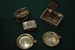 A table lighter, two personal ash trays another ash tray etc.