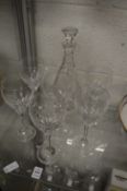 Cut glass decanter and six wine glasses.