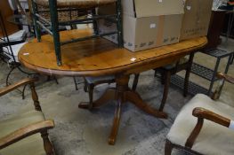 A pine drop-flap pedestal kitchen table.