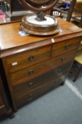 A mahogany chest of drawers with drop-flap lower drawer.