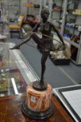 An Art Deco style bronze of 'The Hoop Girl' mounted on a marble base.