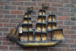 A metal wall sculpture modelled as a three mast sailing ship.