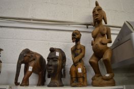 A group of four carved African wood figures.