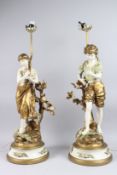A GOOD PAIR OF CHERUB LAMPS on circular bases.