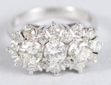 A VERY GOOD DIAMOND TRIPLE CLUSTER RING set in 18ct white gold. Ring size O+.