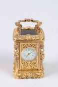 A FRENCH CAST BRONZE MINIATURE CARRIAGE CLOCK. 2.5ins high.