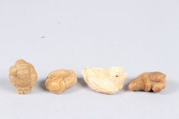 FOUR TAGUA NUT NETSUKES.