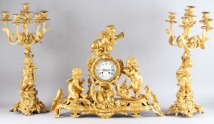 A SUPERB QUALITY LOUIS XVITH ORMOLU THREE PIECE CLOCK GARNITURE. The clock with three cupids,