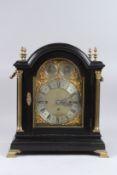 A VICTORIAN EBONISED BREAK ARCHED BRACKET / TABLE CLOCK with brass fittings and reeded brass