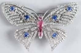 A SILVER BUTTERFLY COMBINED BROOCH / PENDANT set with blue and pink sapphires and several