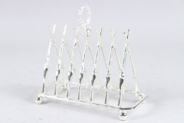 A SILVER PLATE RIFLE TOAST RACK.