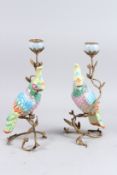 A PAIR OF MULTI-COLOURED PORCELAIN AND GILT METAL PARROT CANDLESTICKS. 12ins high.