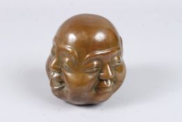 A BRONZE FOUR-FACED BUDDHA HEAD. 4.5ins.
