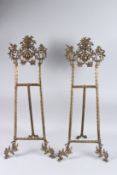 A LARGE PAIR OF BRONZE EASELS. 31ins high.