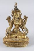 A CHINESE GILT BRONZE FIGURE OF A SEATED DEITY. 6ins high.