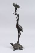 A JAPANESE BRONZE STORK standing on a turtle. 17ins high.