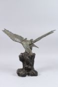 A JAPANESE BRONZE EAGLE on a rustic rock. 14ins high.