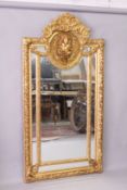 A LARGE DECORATIVE GILT FRAMED SECTIONAL MIRROR, with an oval panel depicting a bust of a young