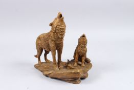 A BRONZE GROUP OF TWO WOLVES. 10ins high.