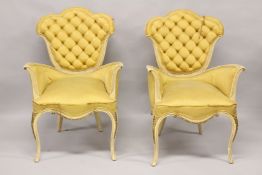 A PAIR OF YELLOW ARMCHAIRS.