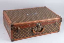 LOUIS VUITTON, A LARGE SUITCASE WITH MONOGRAMMED FABRIC AND LEATHER COVERING, brass locks and