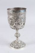 A VERY GOOD INDIAN WHITE METAL CHALICE with oval panels of figures. 9ins high. 430grams.