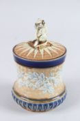 A DOULTON LAMBETH STONEWARE TOBACCO JAR AND COVER. 6.5ins high (slight chip).